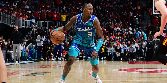 Terry Rozier #3 of the Charlotte Hornets drives to the basket during the game against the Atlanta Hawks during the 2022 Play-In Tournament on April 13, 2022 at State Farm Arena in Atlanta, Georgia.