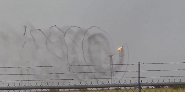 A Texas wind turbine caught on fire after being struck by lightning on Friday, according to video taken by a man who was working in the area.