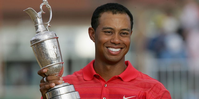 Tiger Woods of the United States poses with a claret jug after a two-shot victory at the end of the final round of The Open Championship at the Royal Liverpool Golf Club in Hoylek, England on July 23, 2006.