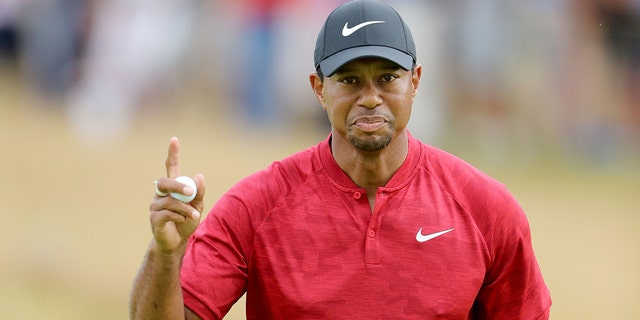 Tiger Woods of the United States accepts the crowd after placing a par put on the ninth hole during the final round of the 147th Open Championship at Carnoustie Golf Club on July 22, 2018 in Carnoustie, Scotland.