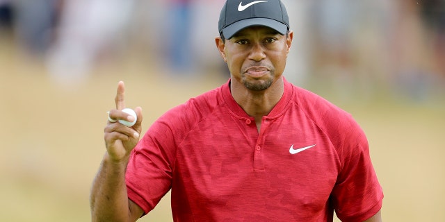 Tiger Woods of the United States acknowledges the crowds after holing a par putt on the ninth hole during the final round of the 147th Open Championship at Carnoustie Golf Club on July 22, 2018 in Carnoustie, Scotland.