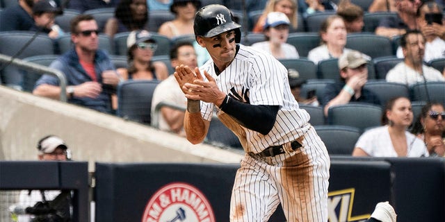 New York Yankees' Tim Locastro celebrates a run during the fourth inning of a baseball game against the Boston Red Sox, Sunday, July 17, 2022, in New York. 