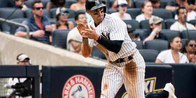 New York Yankees' Tim Locastro celebrates a run during the fourth inning of a baseball game against the Boston Red Sox, Sunday, July 17, 2022, in New York.