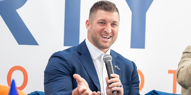 Tim Tebow speaks during the 2022 International Poverty Forum at Porsche Cars North America, March 4, 2022, in Atlanta, Georgia.