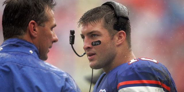 Head coach Urban Meyer, left, and quarterback Tim Tebow during a game between the Troy Trojans and the Florida Gators at Ben Hill Griffin Stadium in Gainesville, Florida.