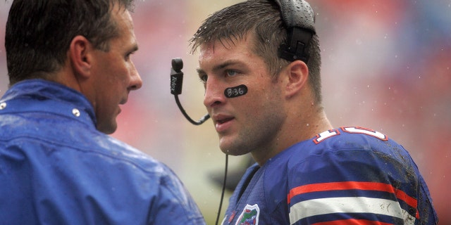 Head coach Urban Meyer, left, and quarterback Tim Tebow during a game between the Troy Trojans and the Florida Gators at Ben Hill Griffin Stadium in Gainesville, Florida.
