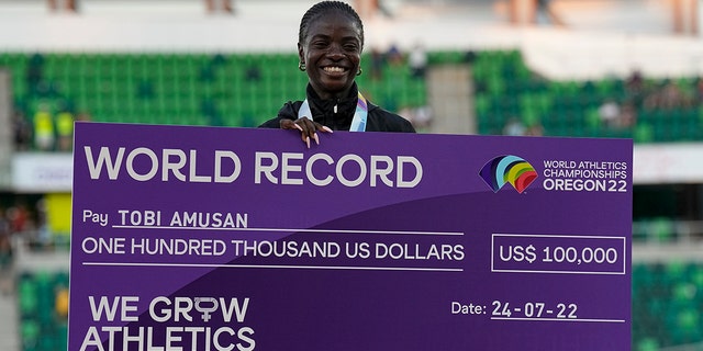 Gold medalist Tobi Amusan, of Nigeria, poses during a medal ceremony for the women's 100-meter hurdles at the World Athletics Championships on Sunday, July 24, 2022, in Eugene, Ore.