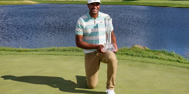 Tony Finau poses for photos with the trophy after his win in the 3M Open golf tournament at the Tournament Players Club in Blaine, Minn., Sunday, July 24, 2022.