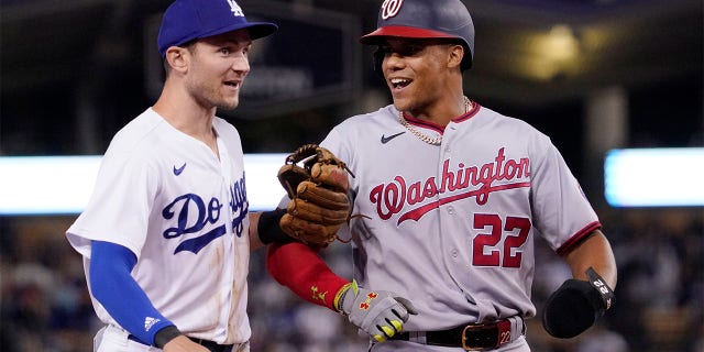 Los Angeles Dodgers' Trea Turner, left, and Washington Nationals' Juan Soto joke around after the end of the top of the seventh inning of a baseball game Monday, July 25, 2022, in Los Angeles.