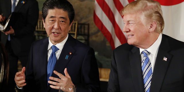 US President Donald Trump is watching Japanese Prime Minister Shinzo Abe speak while dining at Mar-a-Lago's residence in Trump on April 18, 2018 in Palm Beach, Florida.