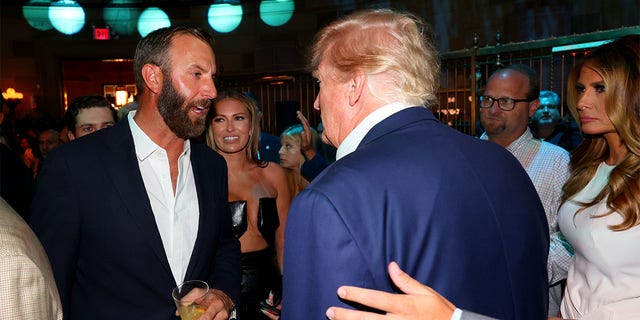 Former President Trump (second from right) talks with Team Captain Dustin Johnson (left) of the 4 Aces GC Bedminster at Gotham Hall in New York, NY July 27, 2022.