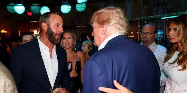 Former President Trump (second from right) talks with Team Captain Dustin Johnson (left) of the 4 Aces GC Bedminster at Gotham Hall in New York, NY July 27, 2022.