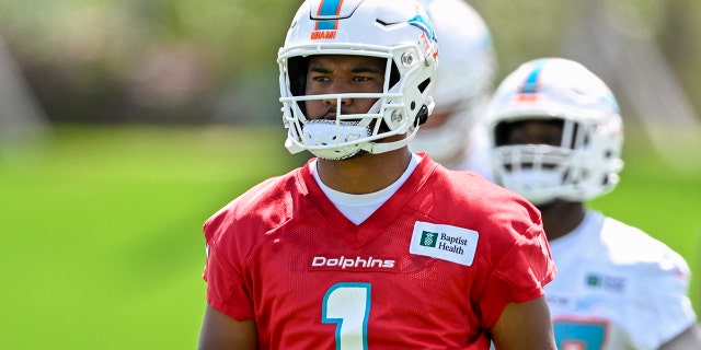 Miami Dolphins quarterback Tua Tagovailoa (1) stretches during the first mandatory minicamp at the Baptist Health Training Complex June 1, 2022, in Miami Gardens, Fla.