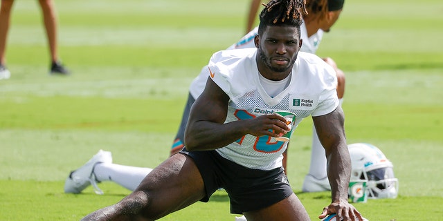 Tyreek Hill, #10 of the Miami Dolphins, stretches during the Miami Dolphins Mandatory Minicamp at the Baptist Health Training Complex on June 2, 2022 in Miami Gardens, Florida.