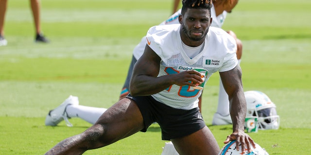 Tyreek Hill, #10 of the Miami Dolphins, stretches during the Miami Dolphins Mandatory Minicamp at the Baptist Health Training Complex on June 2, 2022 in Miami Gardens, Florida.