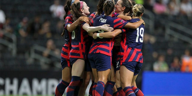 United States' Alex Morgan is congratulated after scoring her side's opening goal from the penalty spot against Canada during the CONCACAF Women's Championship final soccer match in Monterrey, Mexico, Monday, July 18, 2022.