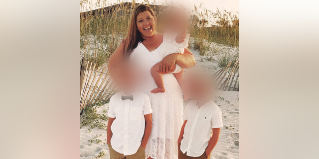 Karen Baker at the beach with her three grandchildren.