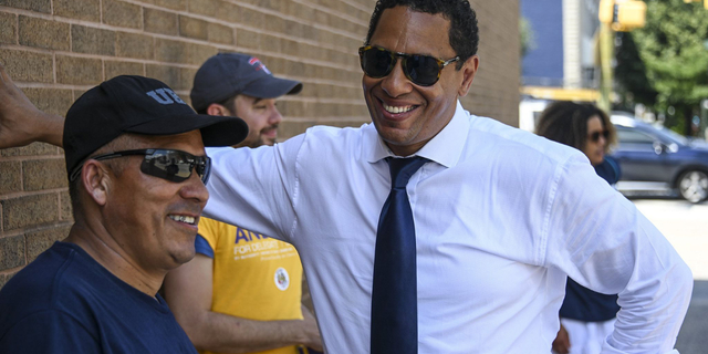 Candidate for Baltimore City States Attorney Ivan Bates shares a laugh with members of his team outside the William Pace Elementary voting location on Tuesday. 