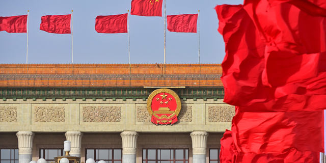 Red flags flutter in front of the Great Hall of the People before the annual two sessions on March 4, 2022 in Beijing, China.