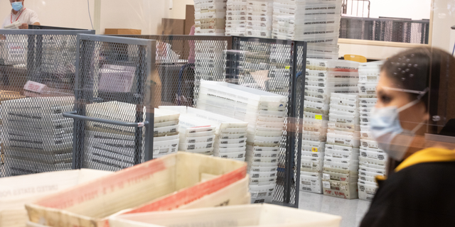 Votes wait to be counted, center, by staff at the Maricopa County Elections Department office on November 5, 2020 in Phoenix, Arizona. 