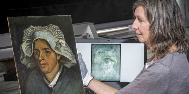 Senior conservator Lesley Stevenson sees a peasant's head next to an X-ray image of Van Gogh's hidden self-portrait. Behind another of the artist's paintings, a previously unknown self-portrait by Vincent Van Gogh was discovered. The National Galleries of Scotland said Thursday it was discovered on the back of Van Gogh "Head of a peasant" when the experts took an X-ray of the canvas before an upcoming exhibition.  (Neil Hanna via AP)