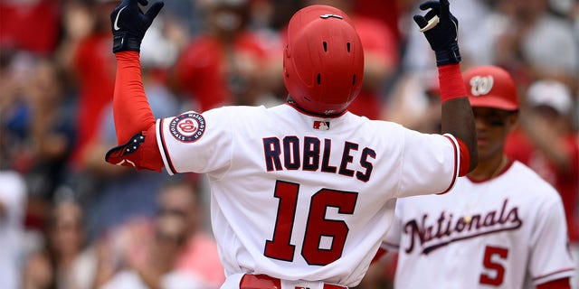 Washington Nationals' Victor Robles (16) celebrates his two-run home run during the second inning of a baseball game against the Atlanta Braves, Sunday, July 17, 2022, in Washington. 