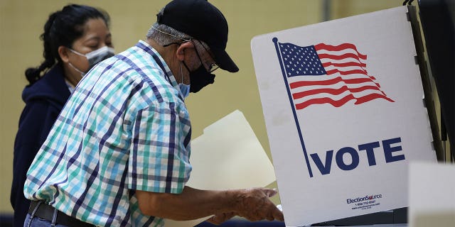 A man casts his ballot at a polling station at Rose Hill Elementary School during the midterm primary election on June 21, 2022, in Alexandria, Virginia.