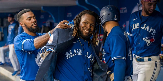 Toronto Blue Jays first baseman Vladimir Guerrero Jr. (27) celebrates with teammates after hitting a two-run home run during the first inning of a baseball game against the St. Louis Cardinals, Tuesday, July 26, 2022 in Toronto.