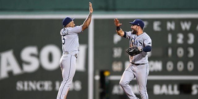 Wander Franco #5 and Kevin Kiermaier #15 of the Tampa Bay Rays celebrate a 7-1 win over the Boston Red Sox at Fenway Park on July 6, 2022 in Boston, Massachusetts. 