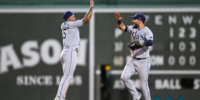 Wander Franco #5 and Kevin Kiermaier #15 of the Tampa Bay Rays celebrate a 7-1 win over the Boston Red Sox at Fenway Park on July 6, 2022 in Boston, Massachusetts.
