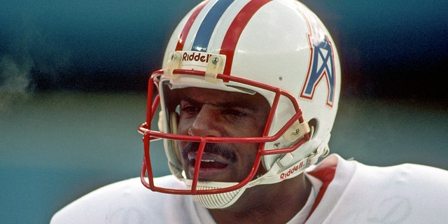 Quarterback Warren Moon of the Houston Oilers watches from the sideline during a Steelers game at Three Rivers Stadium on Dec. 3, 1989, in Pittsburgh, Pennsylvania.