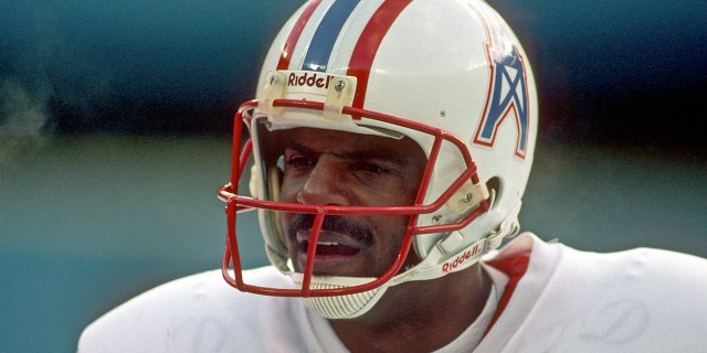 Quarterback Warren Moon of the Houston Oilers watches from the sideline during a Steelers game at Three Rivers Stadium on Dec. 3, 1989, in Pittsburgh, Pennsylvania.