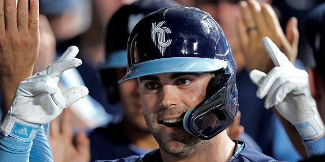 Kansas City Royals' Whit Merrifield celebrates in the dugout after hitting a two-run home run during the eighth inning of a baseball game against the Cleveland Guardians Friday, July 8, 2022, in Kansas City, Mo.