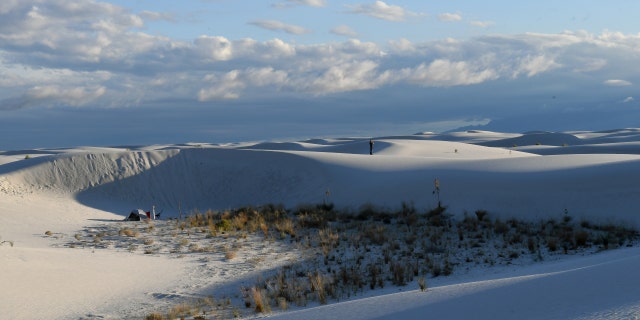 A camper is seen on the ridge of a dune in White Sands National Monument park, the largest of its kind in the world, known for its rare white sand dunes made of gypsum minerals, near Alamogordo, New Mexico, September 27, 2017.