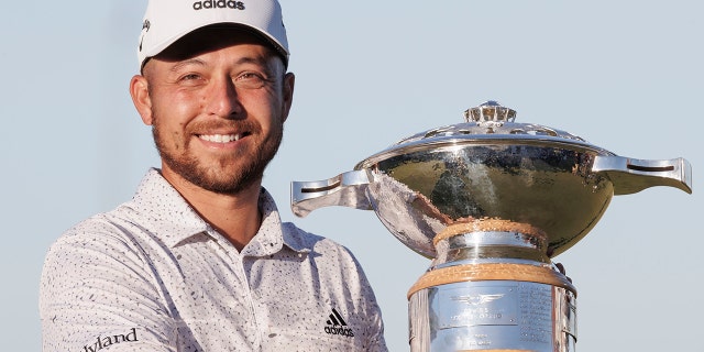 Xander Schauffele holds the trophy after winning the Genesis Scottish Open at The Renaissance Club, North Berwick, Scotland, Sunday July 10, 2022.