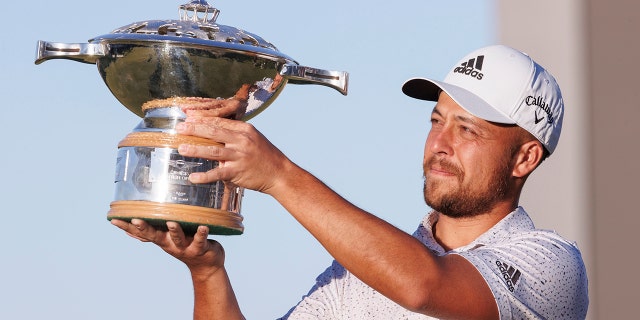 Xander Schauffele holds the trophy after winning the Genesis Scottish Open at The Renaissance Club, North Berwick, Scotland, Sunday July 10, 2022.