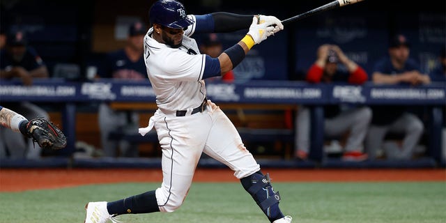 Tampa Bay Rays' Yandy Diaz hits an RBI single against the Boston Red Sox during the seventh inning of a baseball game Wednesday, July 13, 2022, in St. Petersburg, Fla. 