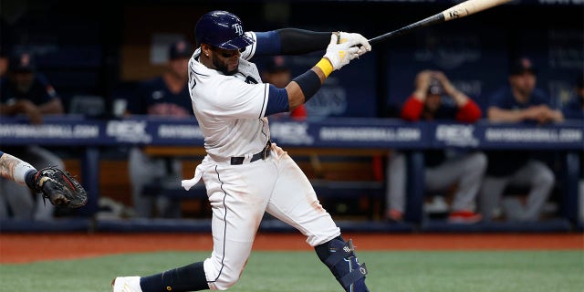 Tampa Bay Rays' Yandy Diaz hits an RBI single against the Boston Red Sox during the seventh inning of a baseball game Wednesday, July 13, 2022, in St. Petersburg, Fla.