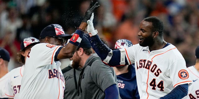 Houston Astros designated hitter Yordan Alvarez (44) celebrates his walkoff home run with manager Dusty Baker during the ninth inning of a baseball game against the Kansas City Royals on Monday, July 4, 2022 in Houston. 