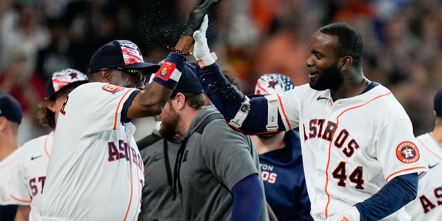 Houston Astros designated hitter Yordan Alvarez (44) celebrates his walkoff home run with manager Dusty Baker during the ninth inning of a baseball game against the Kansas City Royals, Monday, July 4, 2022, in Houston. 