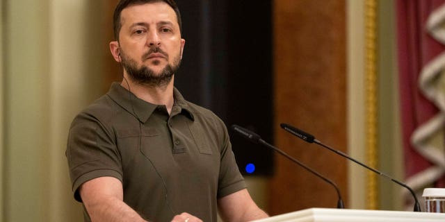 Ukrainian President Volodymyr Zelenskyy stands at the podium during a joint news conference with Australian Prime Minister Anthony Albanese, in Kyiv, Ukraine, July 3, 2022.