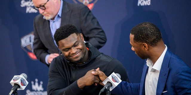 New Orleans Pelicans forward Zion Williamson shakes hands with New Orleans Pelicans head coach Willie Green with New Orleans Pelicans vice president of basketball operations David Griffin standing in the background after talking to the media about signing his contract extension at the Dryades YMCA in New Orleans, Wednesday, July 6, 2022.