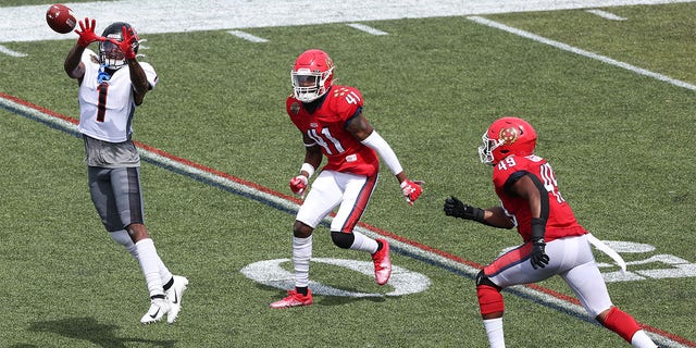 Isaiah Zuber (1) of the Houston Gamblers jumps to catch the ball as De'Vante Bausby (41) and Angelo Garbutt (49) of the New Jersey Generals defend in the first quarter at Protective Stadium May 21, 2022, in Birmingham, Ala. 