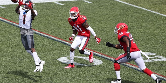 Isaiah Zuber (1) of the Houston Gamblers jumps to catch the ball as De'Vante Bausby (41) and Angelo Garbutt (49) of the New Jersey Generals defend in the first quarter at Protective Stadium May 21, 2022, in Birmingham, Ala. 