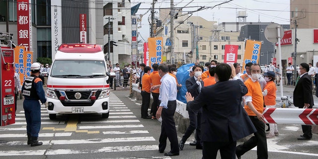 People react after gunshots in Nara, western Japan Friday, July 8, 2022. Japan’s former Prime Minister Shinzo Abe was in heart failure after apparently being shot during a campaign speech Friday in western Japan, NHK public television said Friday.