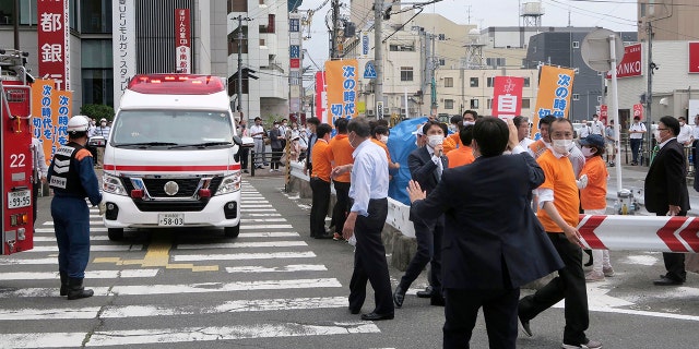 People react after gunshots in Nara, western Japan Friday, July 8, 2022. Japan’s former Prime Minister Shinzo Abe was in heart failure after apparently being shot during a campaign speech Friday in western Japan, NHK public television said Friday. (Kyodo News via AP)