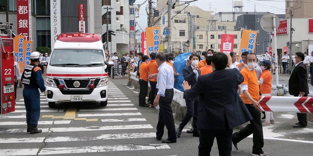 People react after gunshots in Nara, western Japan Friday, July 8, 2022. Japan’s former Prime Minister Shinzo Abe was in heart failure after apparently being shot during a campaign speech Friday in western Japan, NHK public television said Friday.