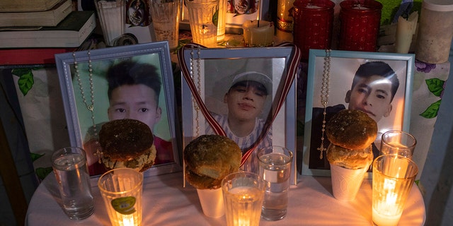 FILE - Photos of Jair Valencia, left, Misael Olivares, center, and Yovani Valencia are displayed on an altar at their home in San Marcos Atexquilapan, Veracruz state, Mexico, on July 13, 2022. 