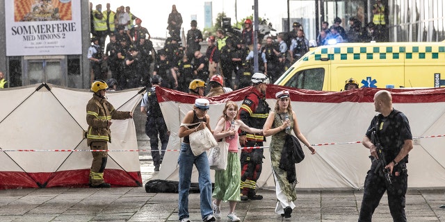 People leave the Field's shopping center in Copenhagen, Denmark Sunday, July 3, 2022. A gunman opened fire inside the busy shopping mall in the Danish capital Sunday, killing a few people and critically wounding a few others, police said. 