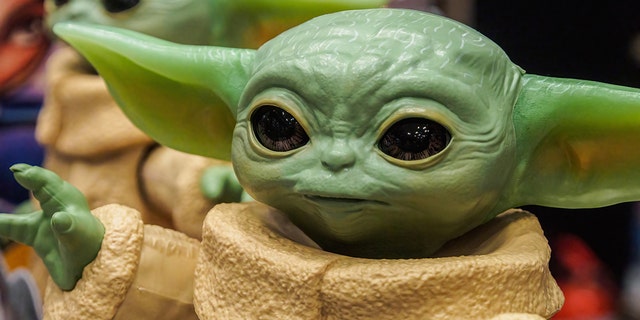 A figurine of the main character of the popular TV series "Mandalorian" Grogu (Baby Yoda) seen in a store. 